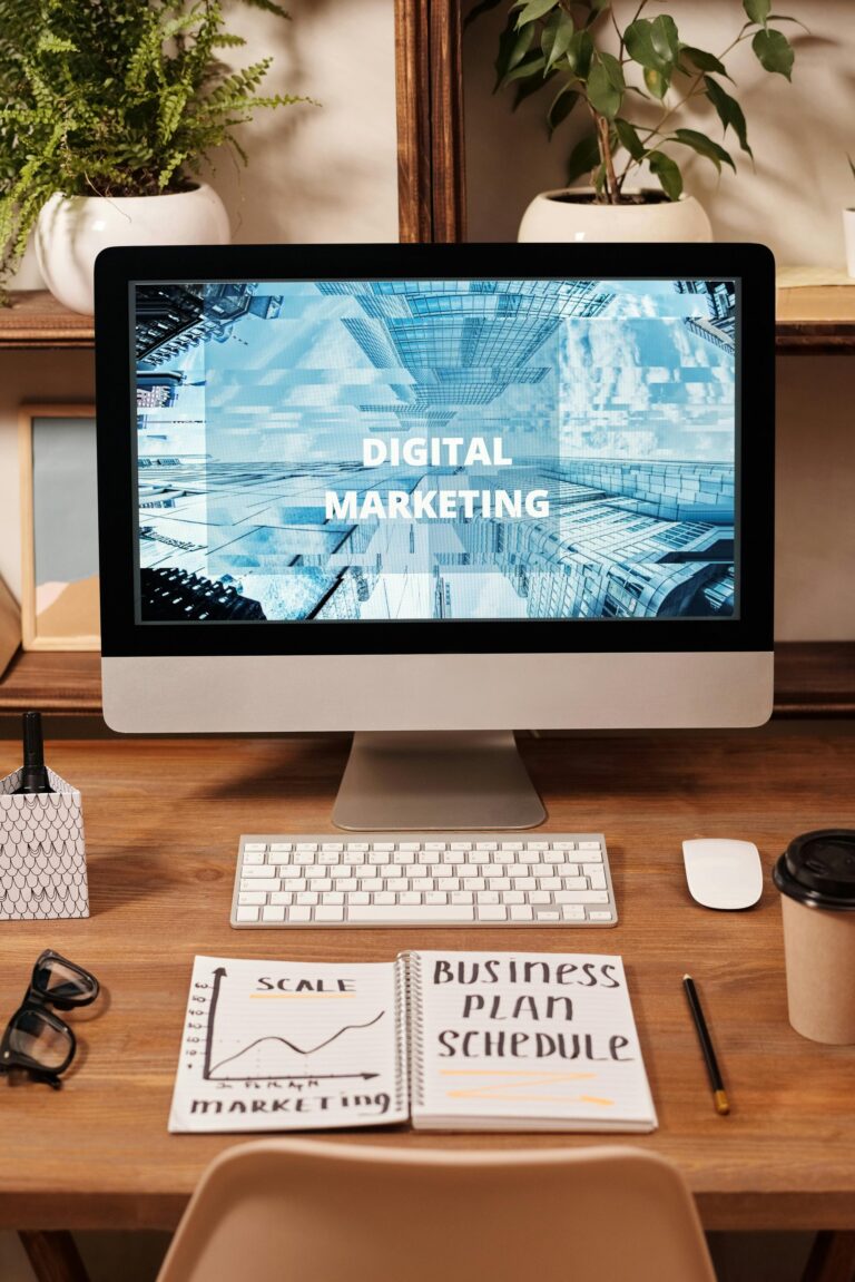 an image of a computer on a desk with the words digital marketing spelled across the screen